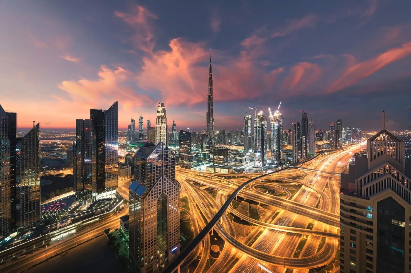 Business Bay vs Downtown Dubai: Dubai skyline with the Burj Khalifa above the Sheikh Zayed Road interchange
