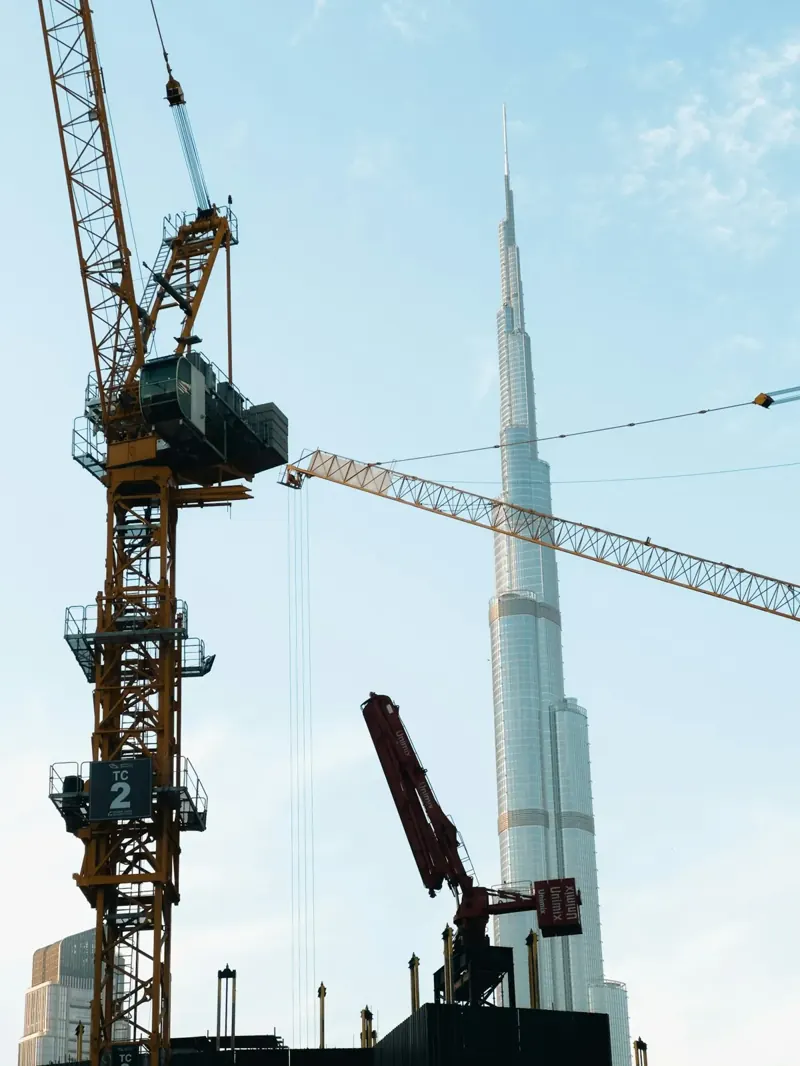 Construction crane beside a tower, showing the build stage behind Dubai off-plan payment plans