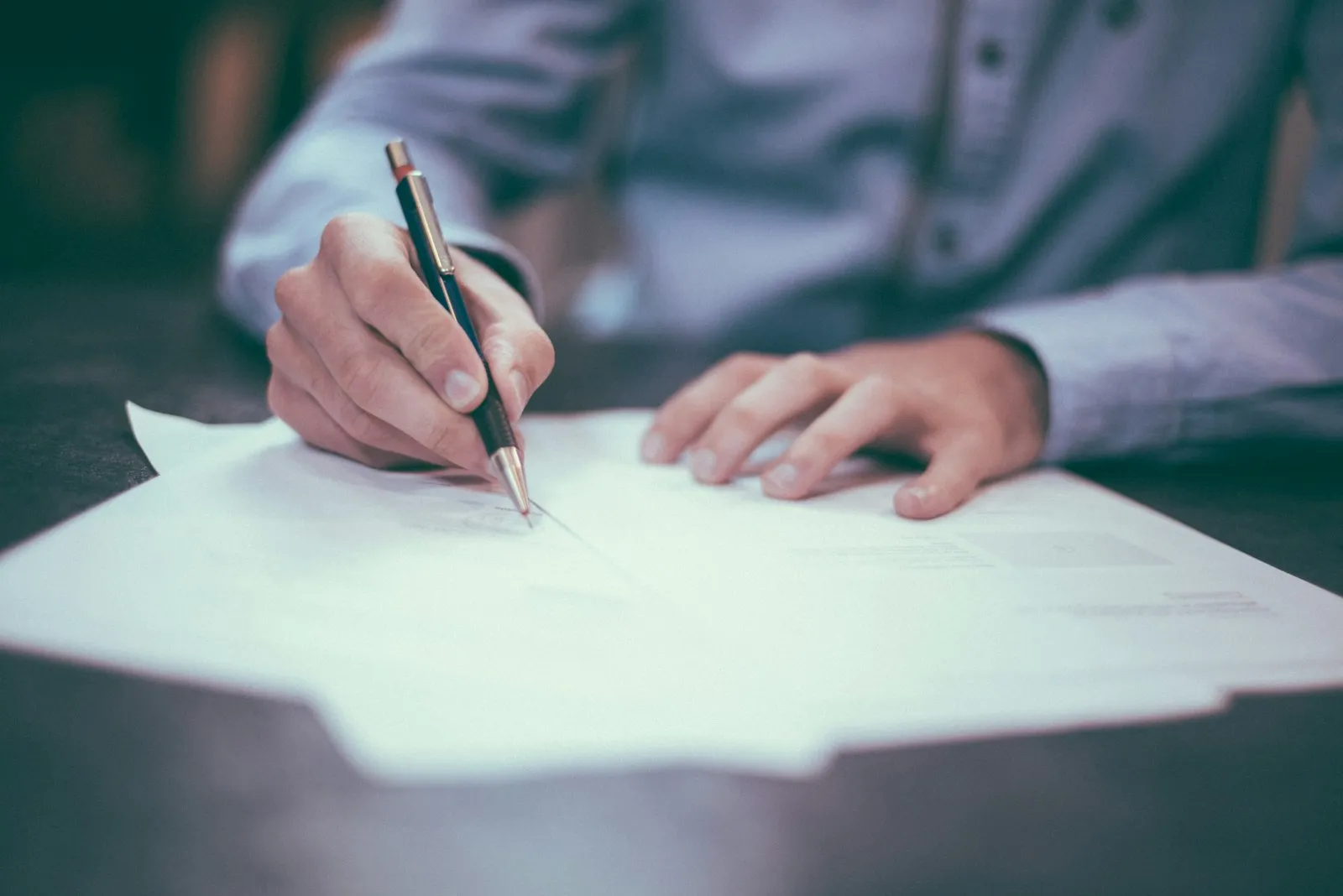 Buyer reviewing and signing an off-plan contract, where the Dubai escrow account details should be stated