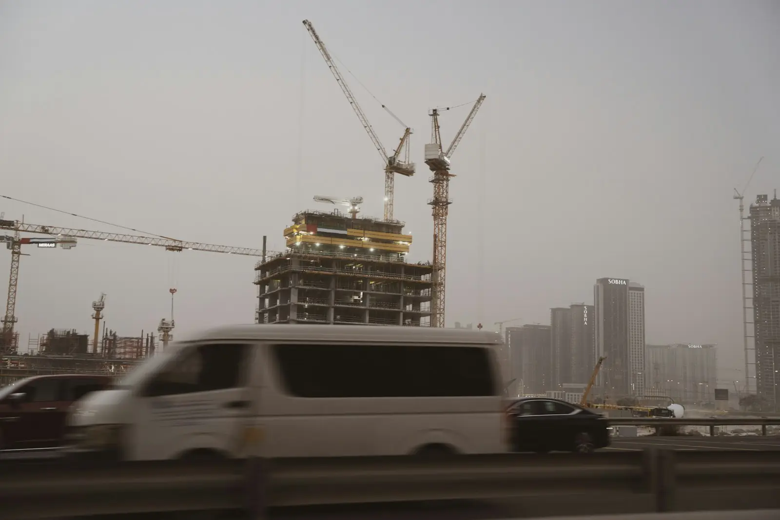 Off-plan vs ready property Dubai: a residential tower under construction with cranes