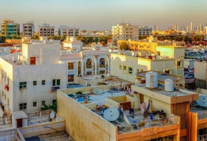 Selling property in Dubai: rooftops of older Dubai apartment buildings with the skyline behind