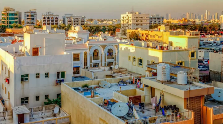 Selling property in Dubai: rooftops of older Dubai apartment buildings with the skyline behind