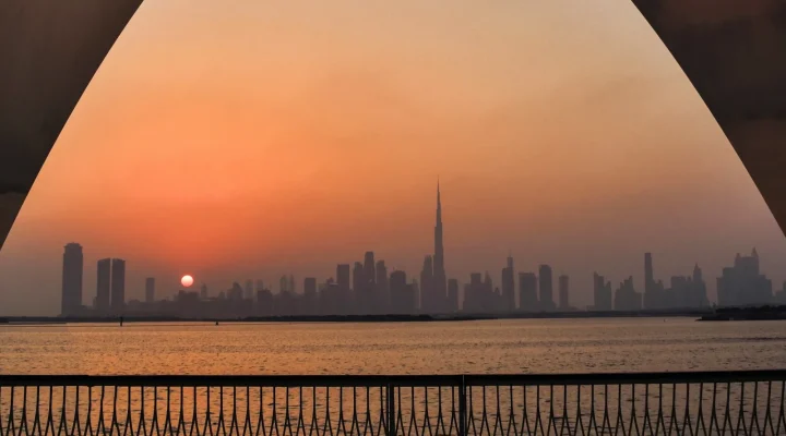 Dubai Creek Harbour waterfront at sunset with the Dubai skyline and Burj Khalifa
